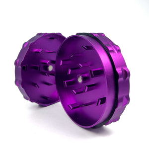 Purple 2 piece grinder with notched grooves for a precise and efficient herb grind, made from durable aluminum.