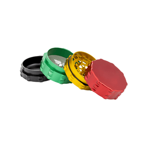 Custom 4 piece grinder in black, green, yellow, and red, showcasing sleek design and precision craftsmanship.
