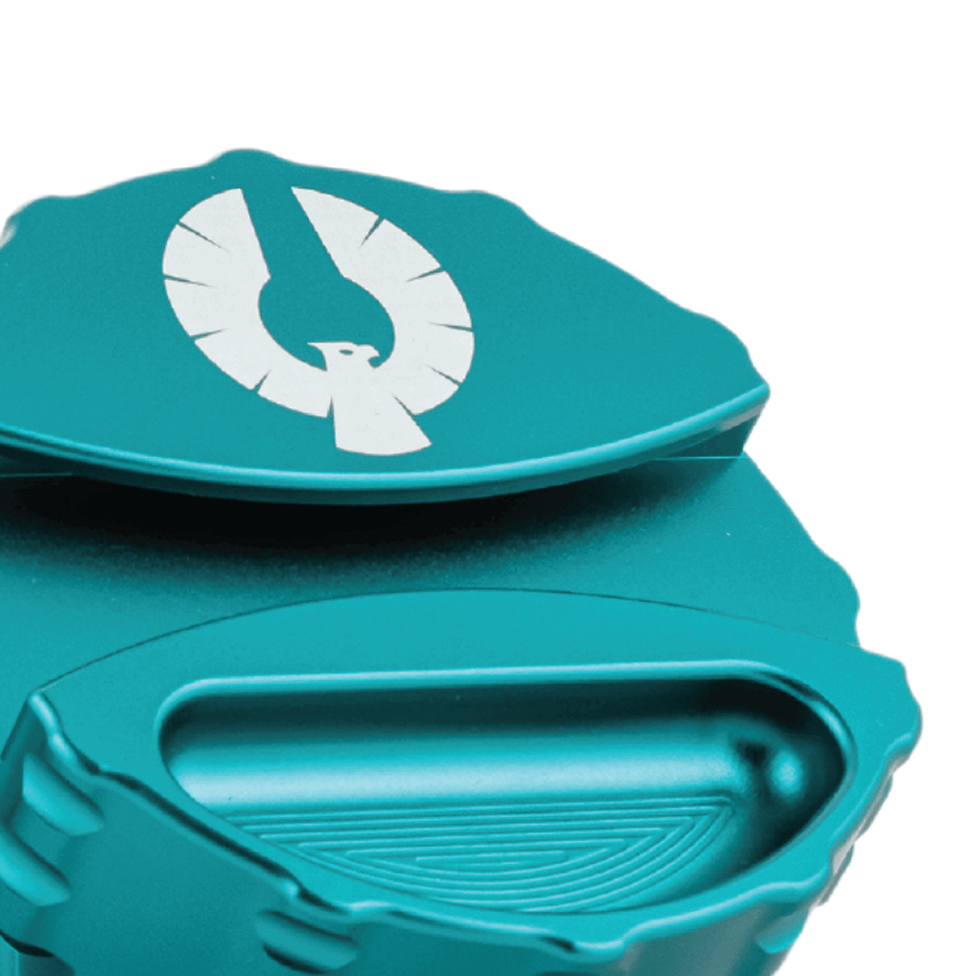 Close-up of the Phoenician 4 Piece Large weed grinder, featuring a teal finish and integrated paper holder.