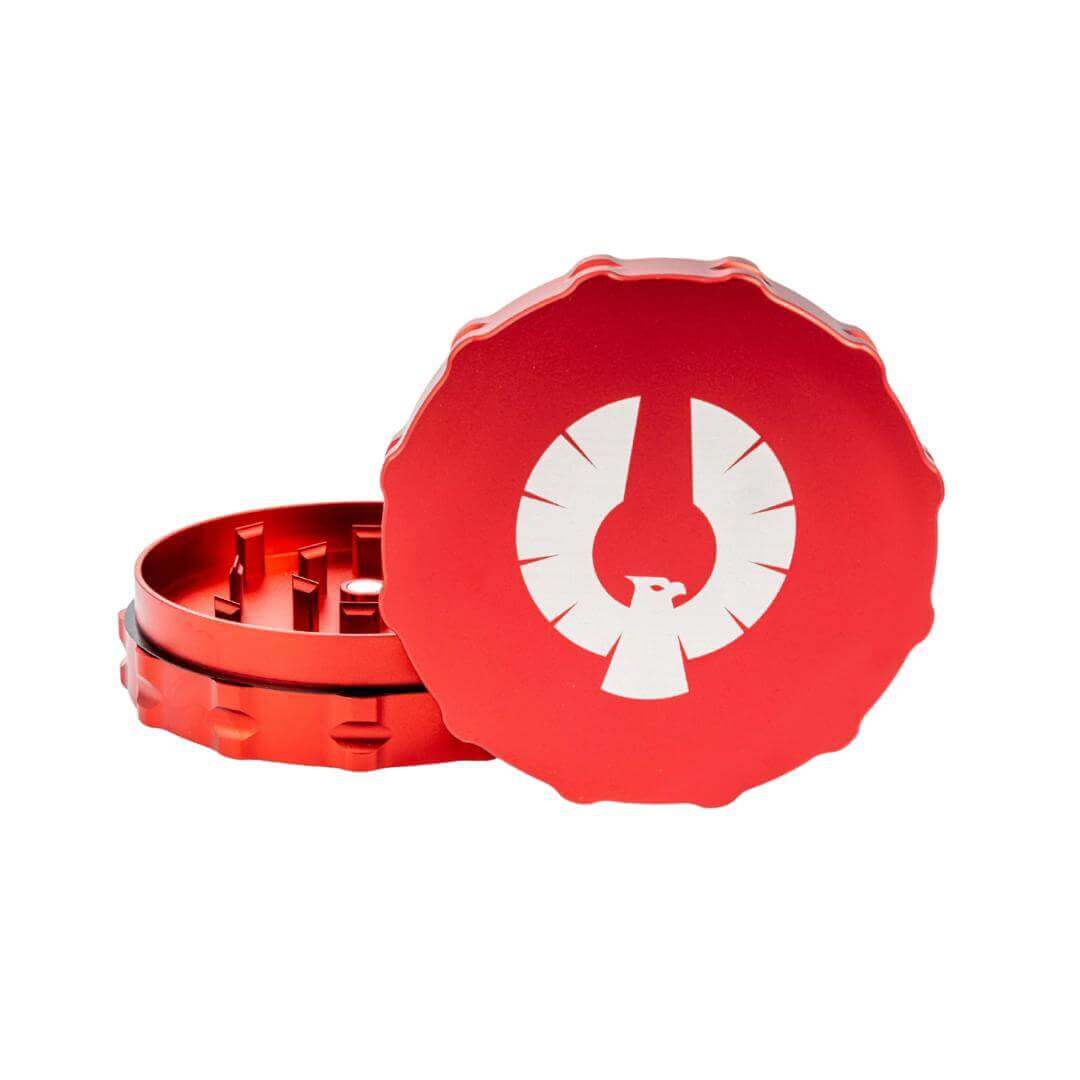 Red 2 piece Phoenician grinder with notched groove design, featuring sharp teeth for premium herb grinding.