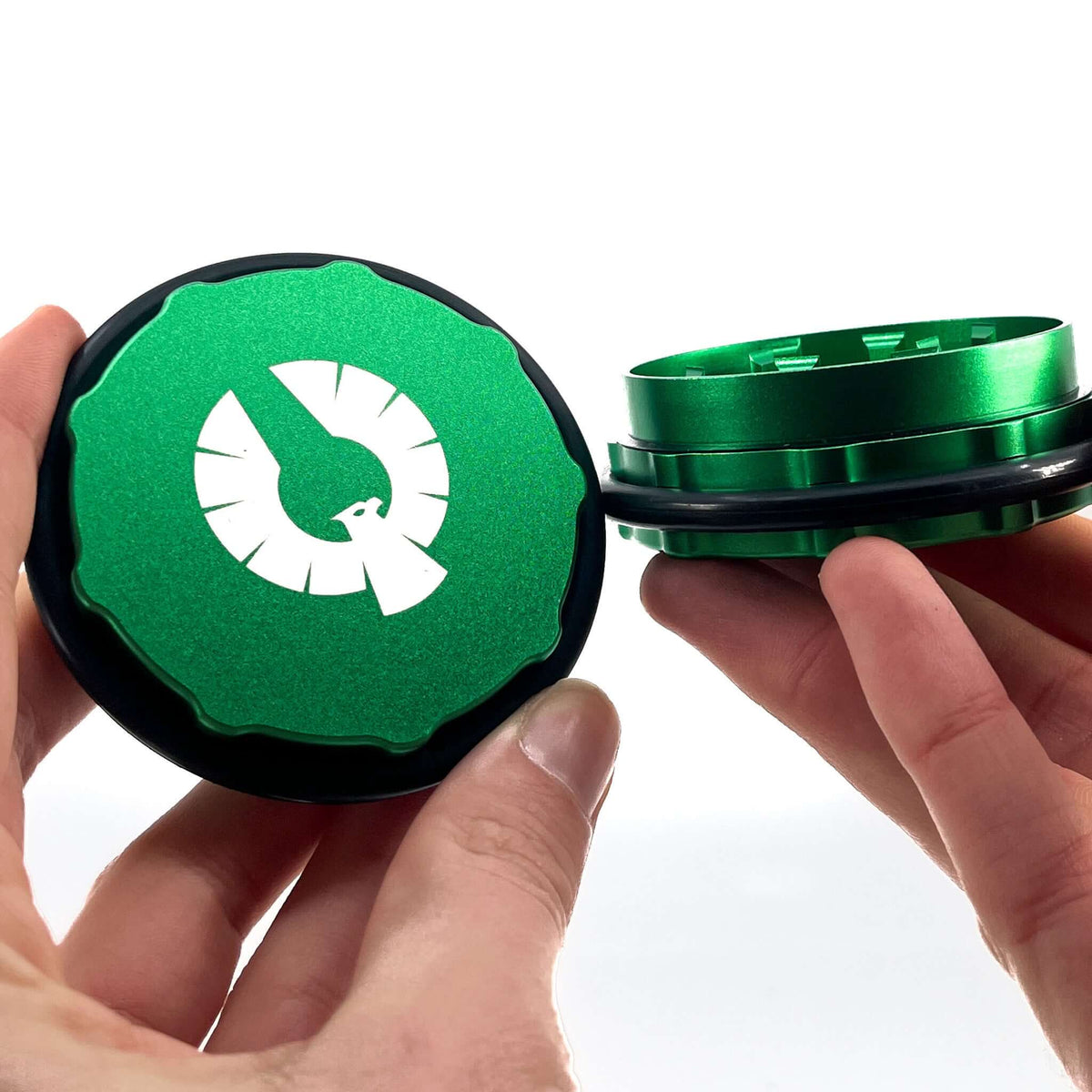 Two-piece green herb grinder crafted from durable aluminum, showcasing precise engineering for an optimal cannabis grinding experience.