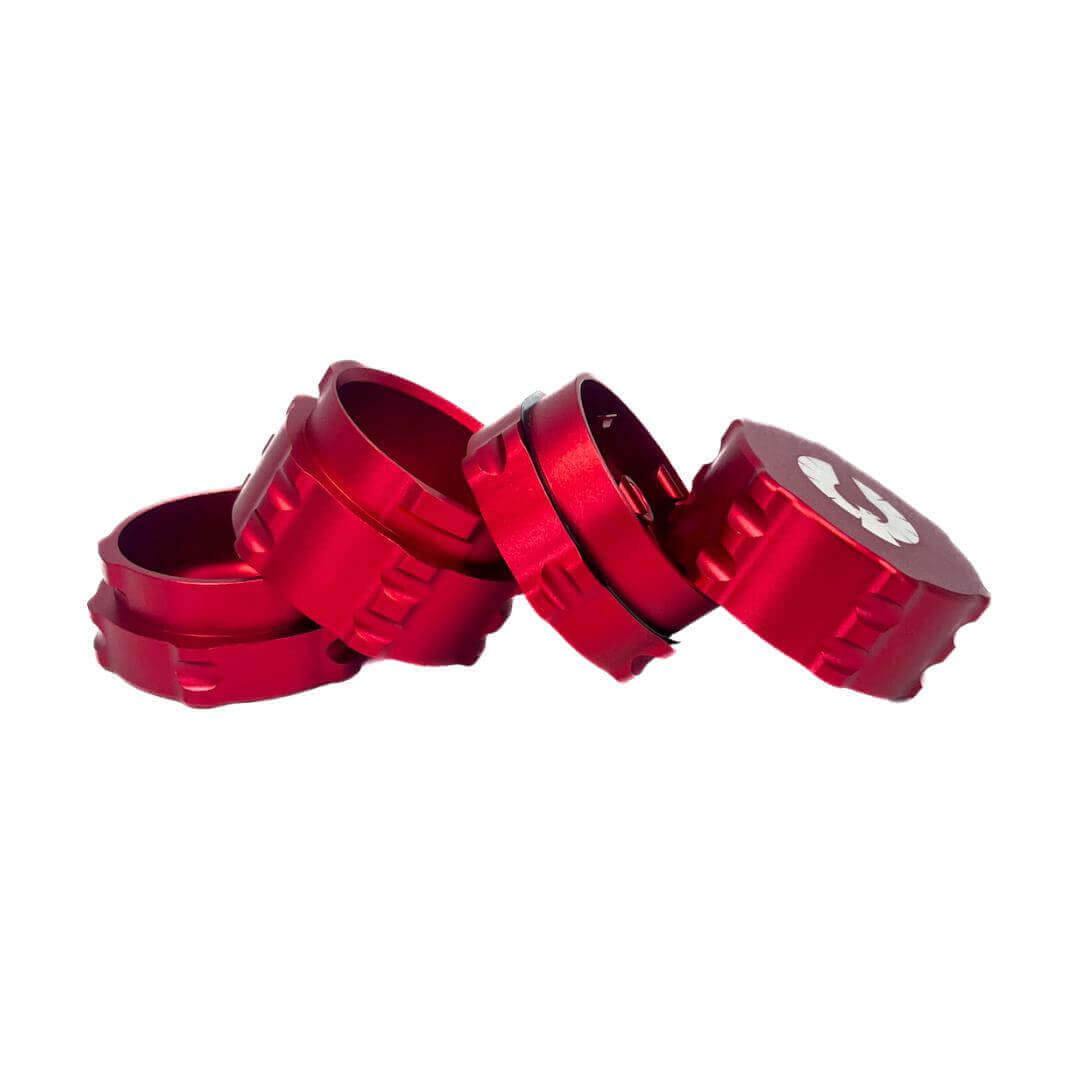 Red 4 piece herb grinder stacked, showcasing a sleek design for cannabis enthusiasts. Ideal small grinder for sale.