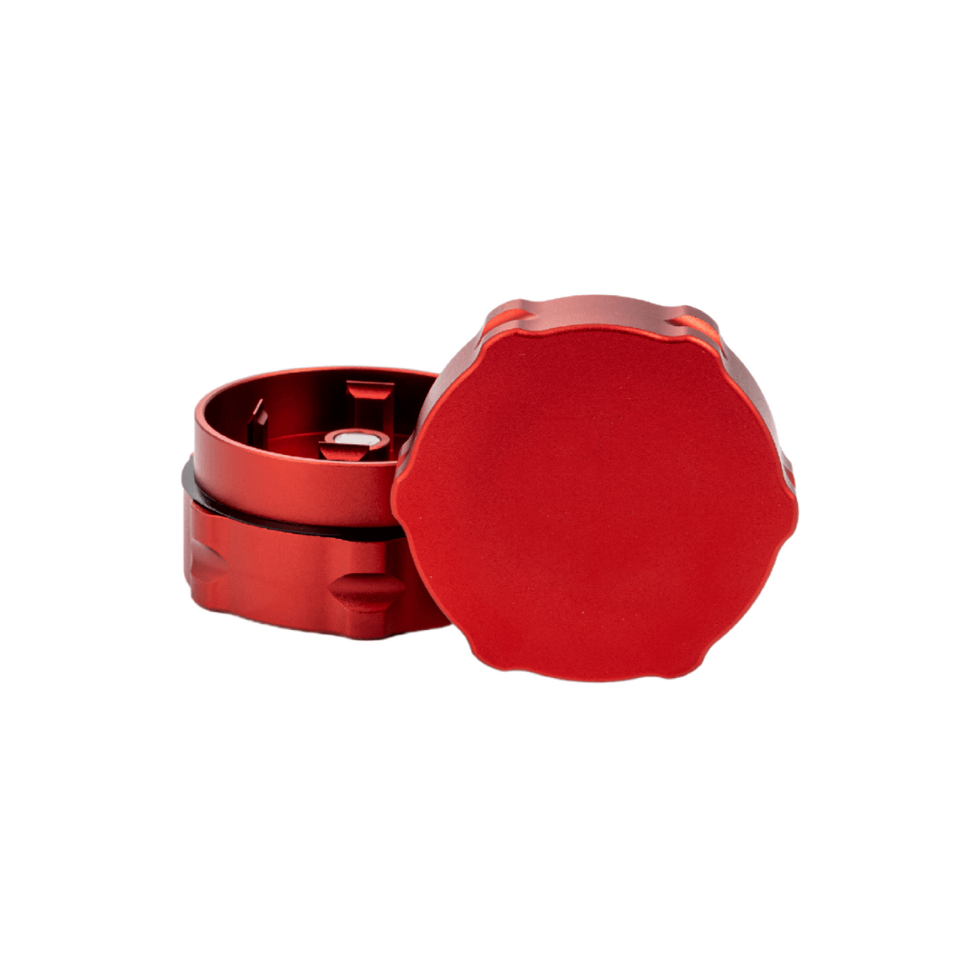 Custom red weed grinder showcasing compact design and smooth finish for dispensary use.